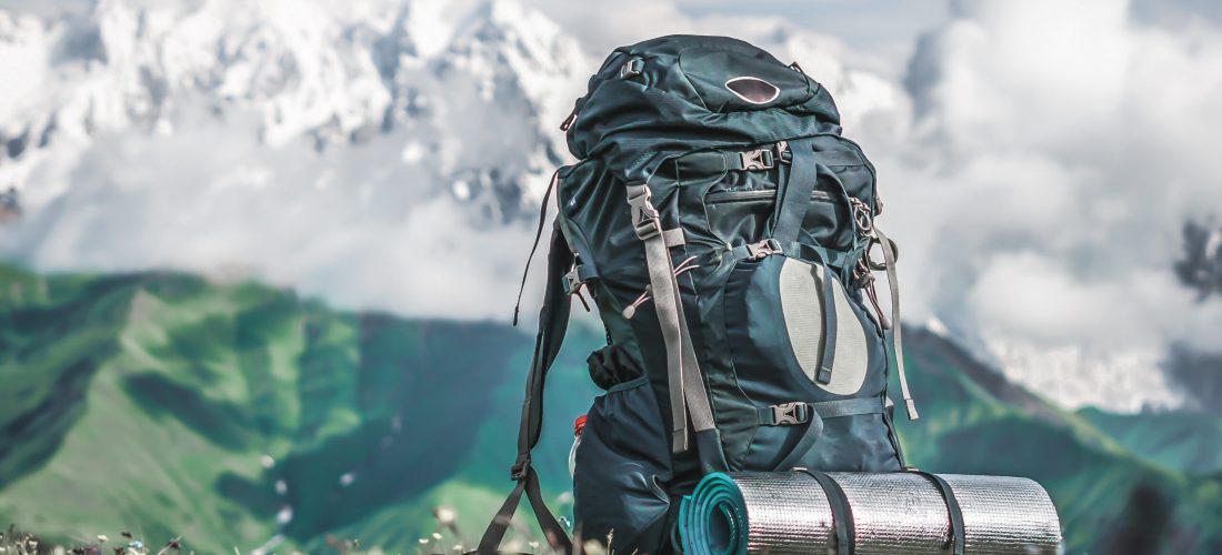 Tourist backpack and sleeping pad on a background of mountains, Georgia (Svaneti)